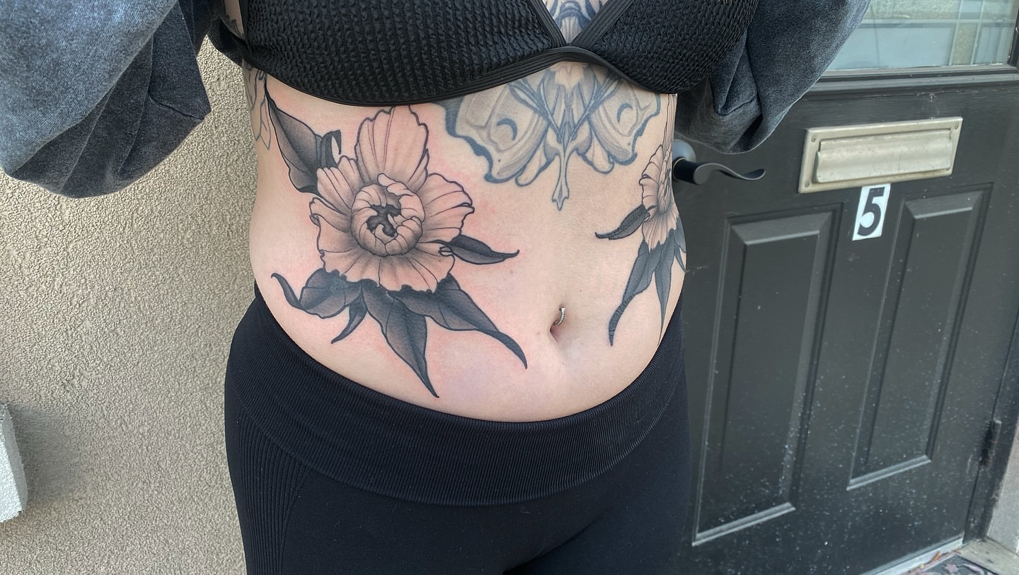 Peony black and grey tattoo on the torso by Jake Kirk