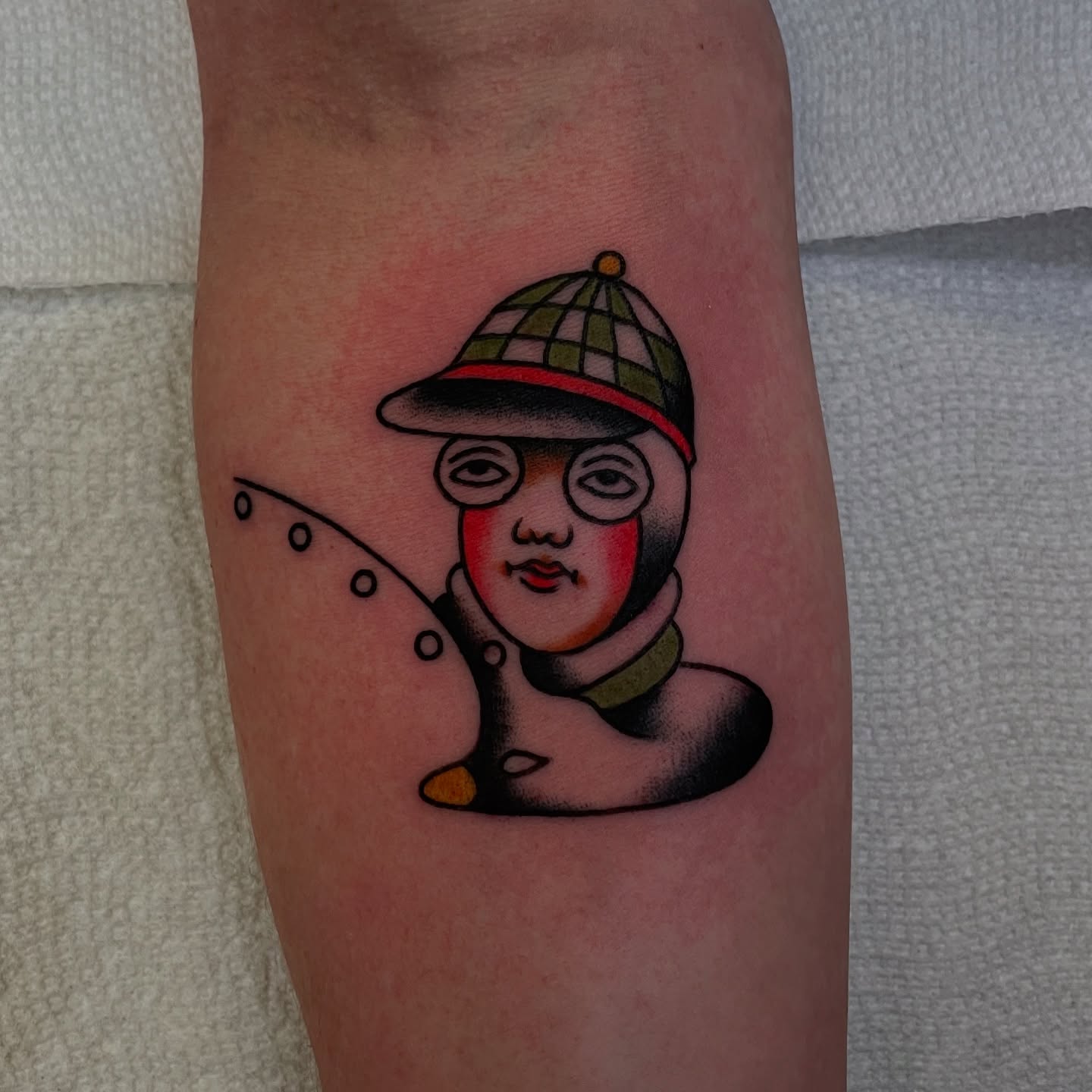 Fishing man American traditional tattoo on the forearm by Texas Jonah