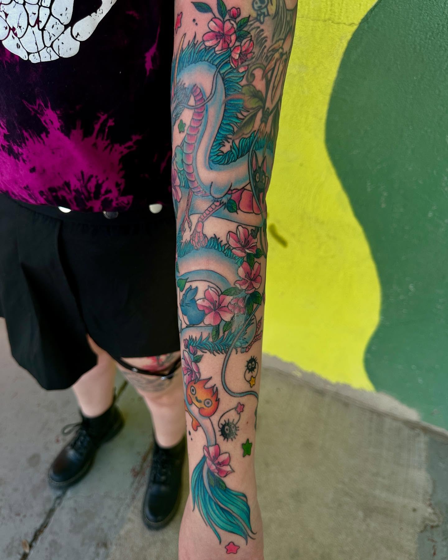 Serpent and flowers new school tattoo on the forearm by Holle Hellfire