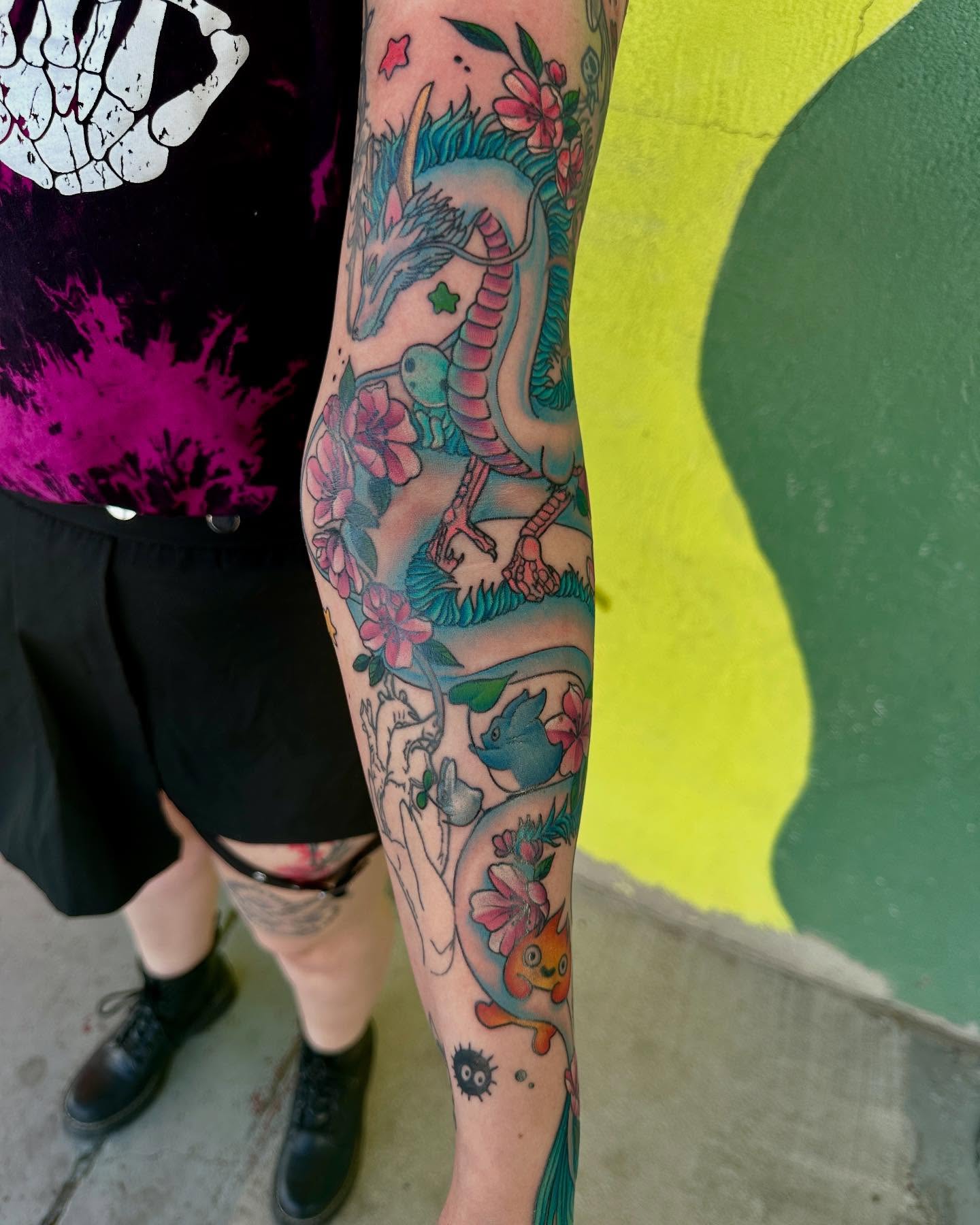 Dragon and flowers new school tattoo on the forearm by Holle Hellfire