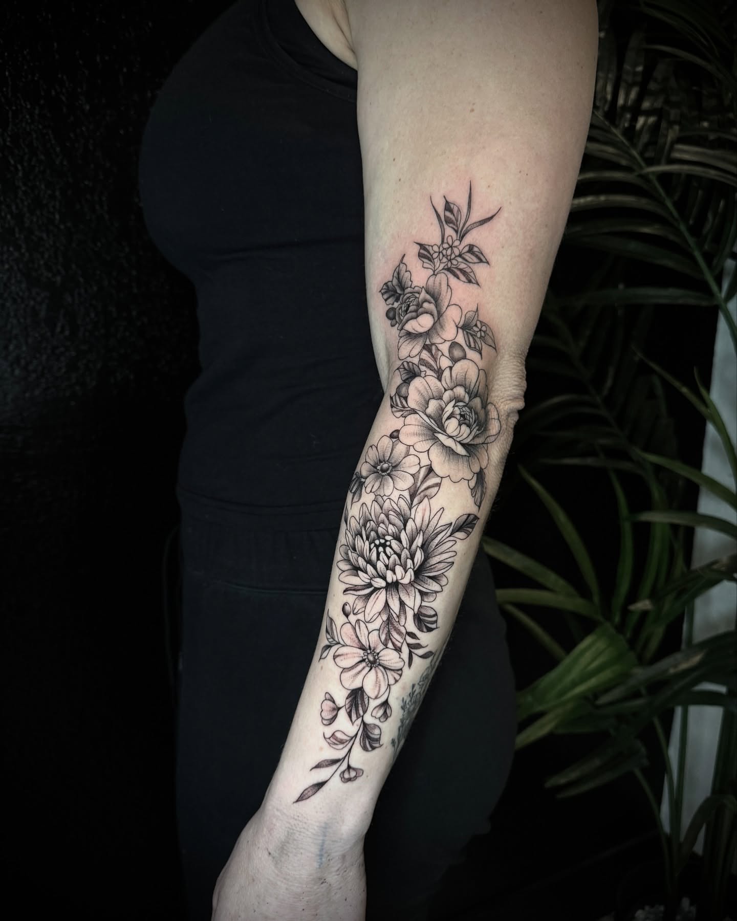 Floral bouquet black and grey tattoo on the forearm by Chip