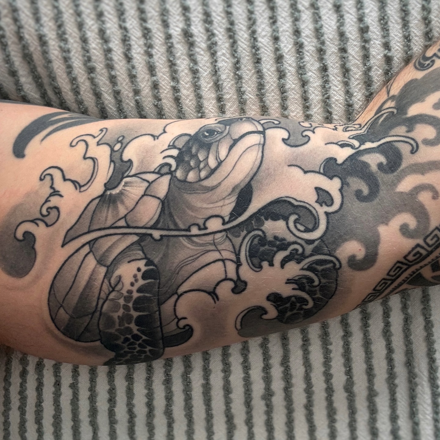 Bulldog black and grey tattoo on the forearm by Anne Cornelson