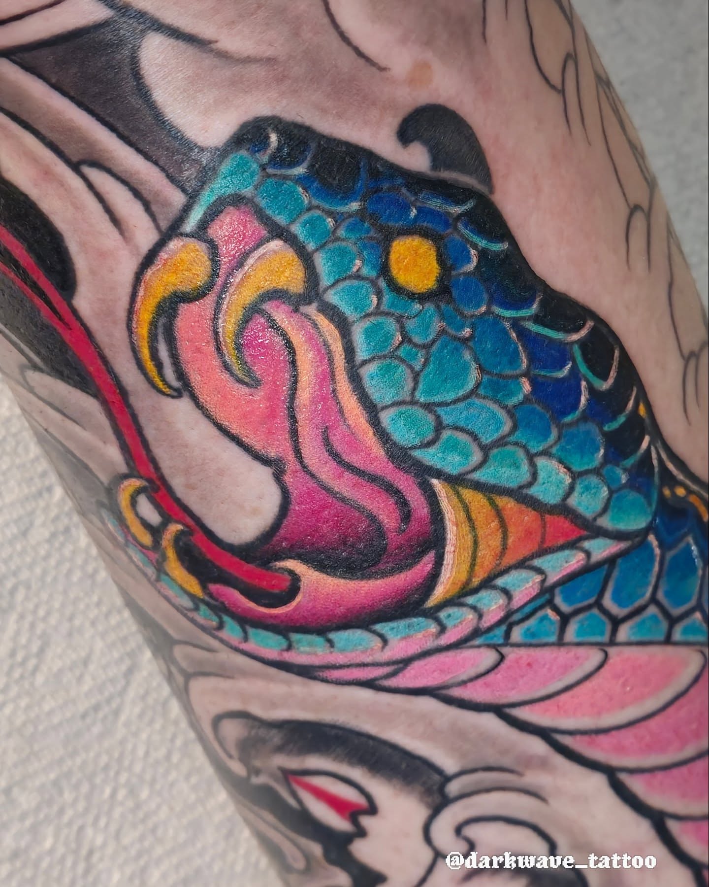 Koi fish American traditional tattoo on the forearm by Barrett Handel