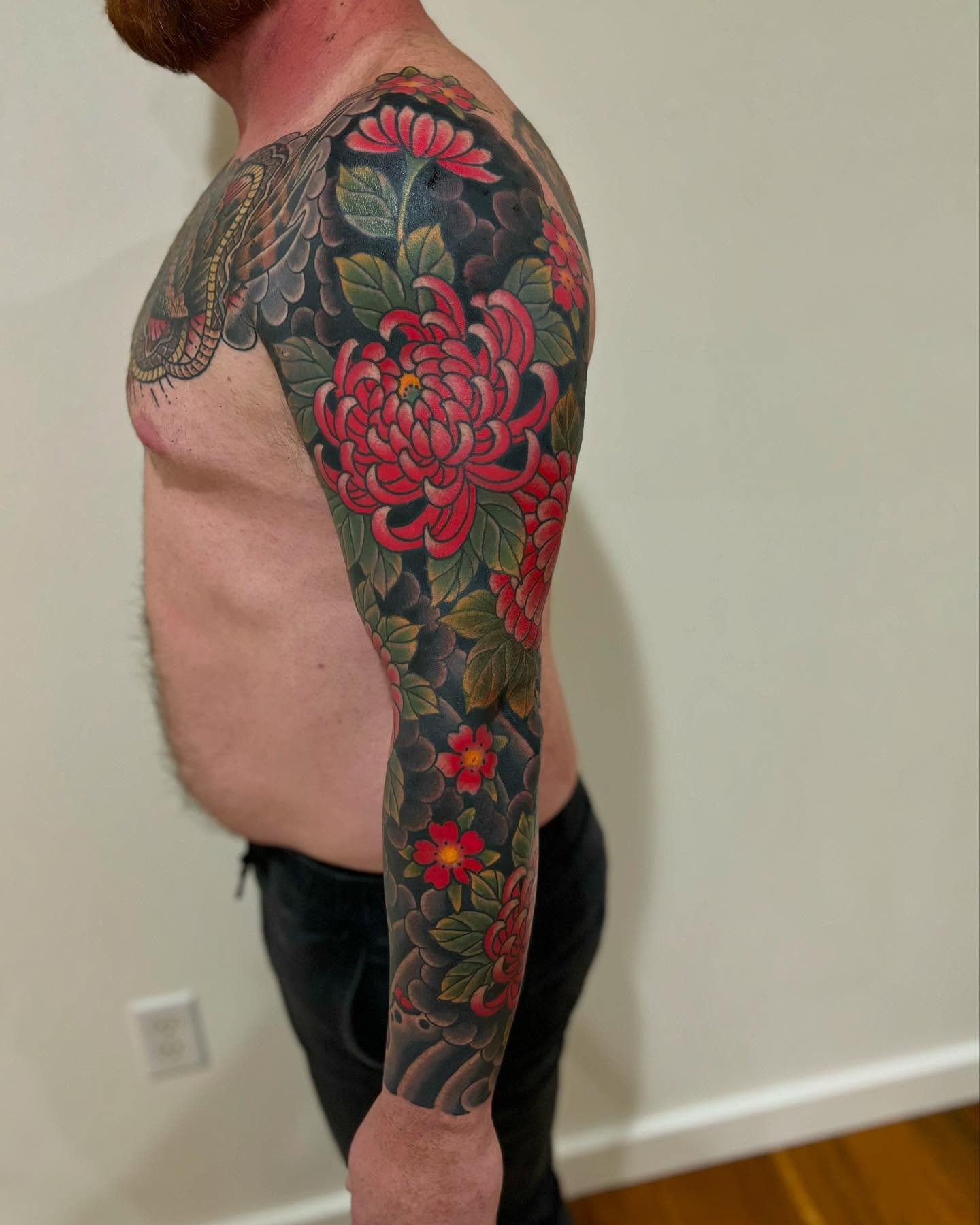 Chrysanthemum japanese irezumi tattoo on the upper arm by Cody Collins