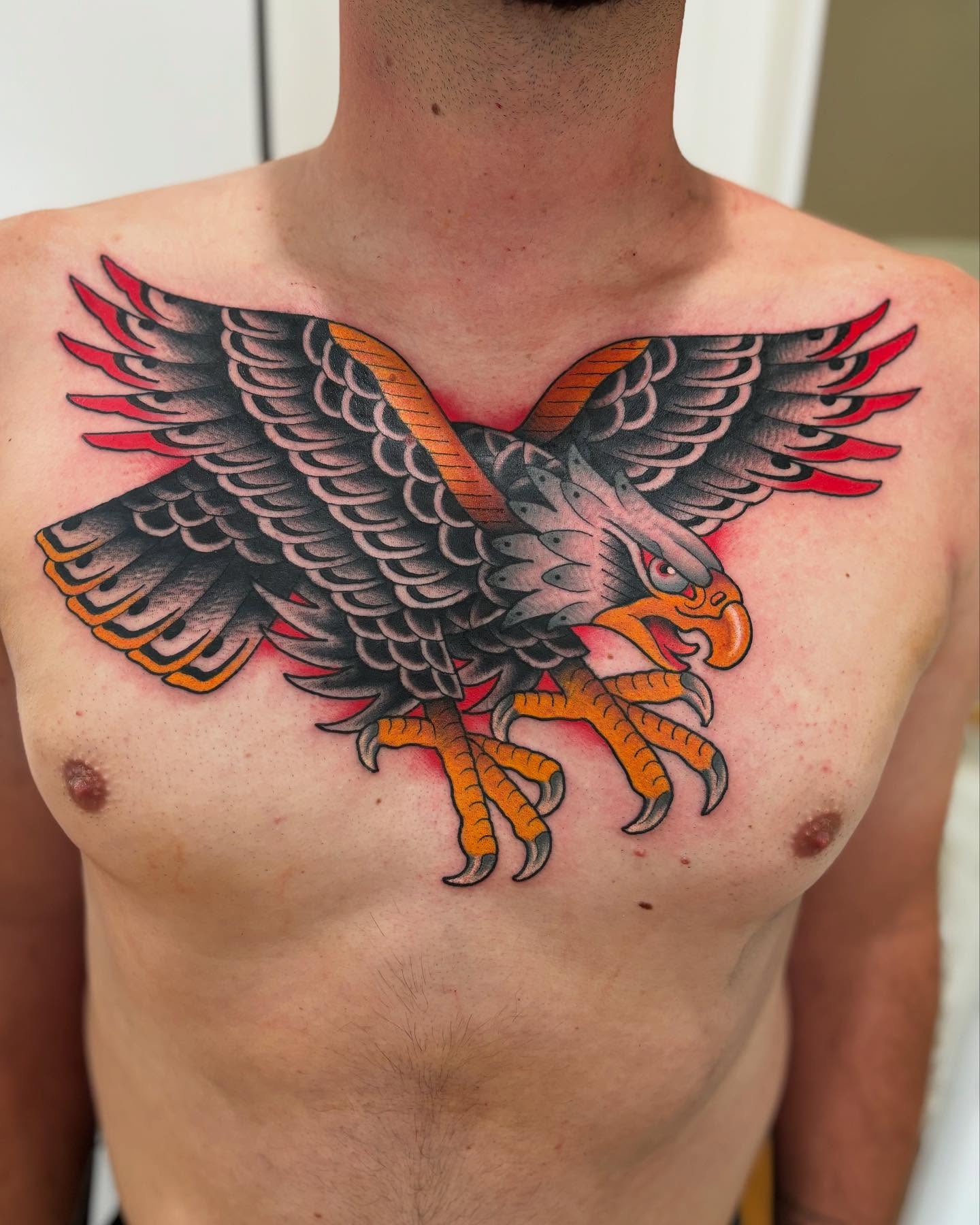 Eagle American traditional tattoo on the chest by Cody Collins