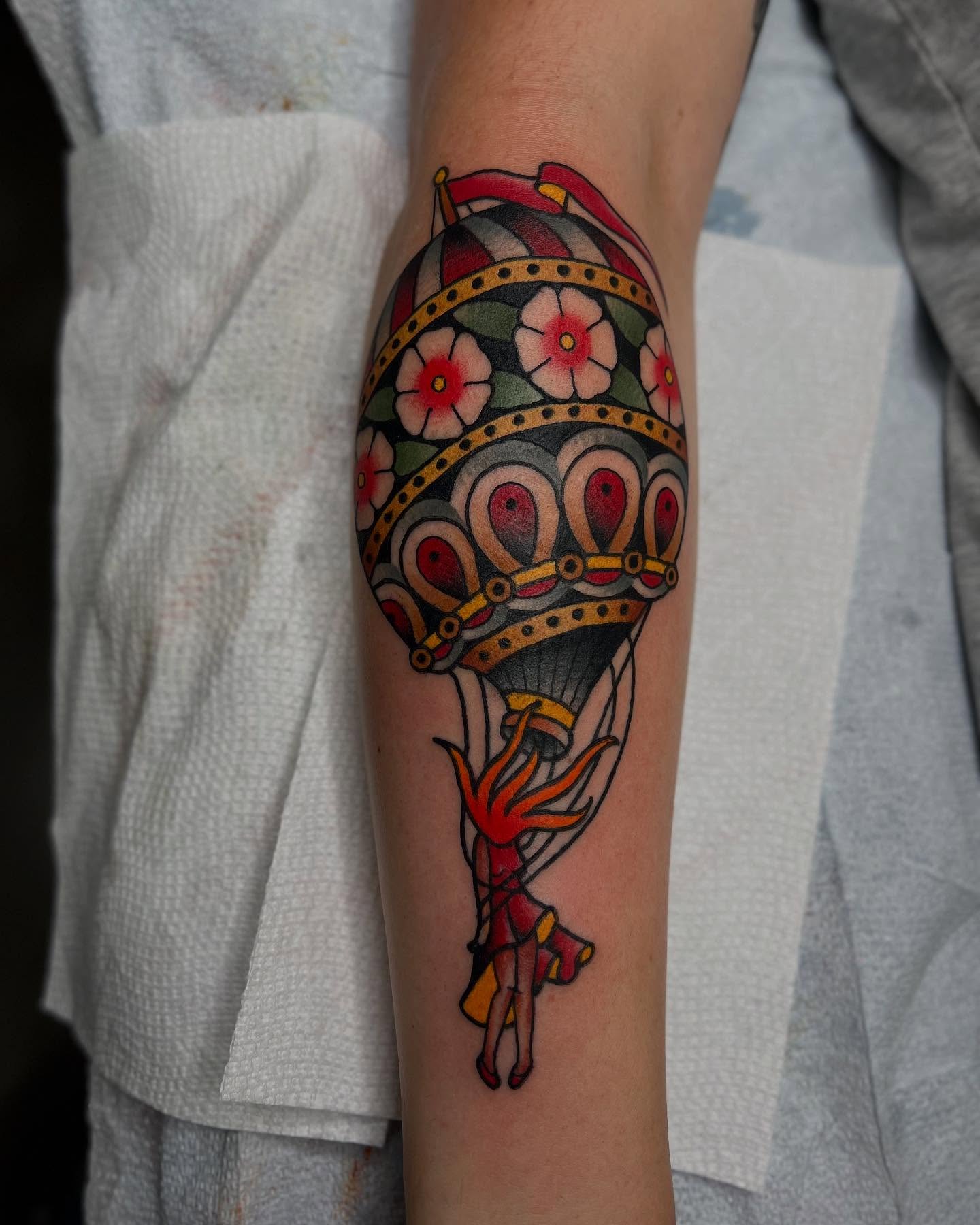 Hot air balloon American traditional tattoo on the forearm by Cody Collins