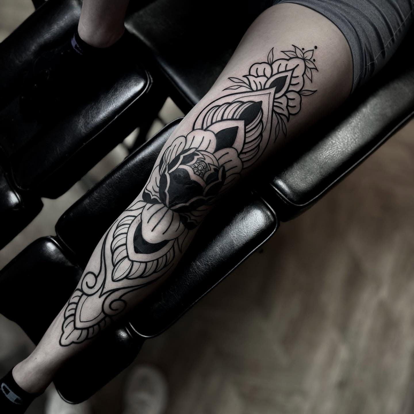 Floral design black and grey tattoo on the forearm by t a y l o r