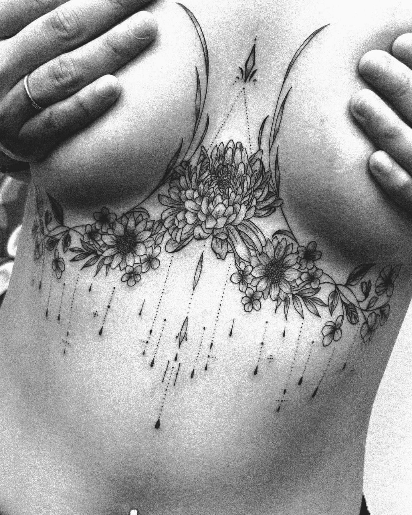 Floral arrangement dotwork tattoo on the chest by Kraken ink Tattoo, San Francisco, California