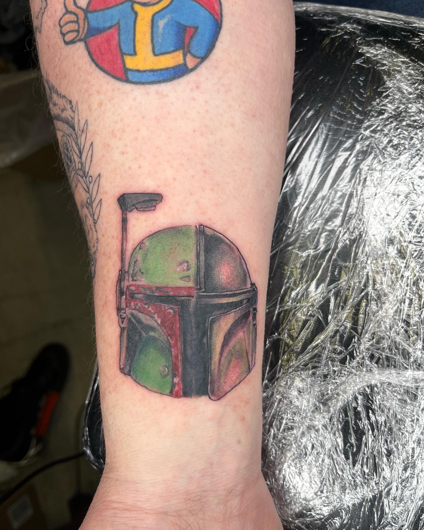 Boba Fett helmet realism tattoo on the forearm by Darius Armour (Tattoo Artist)