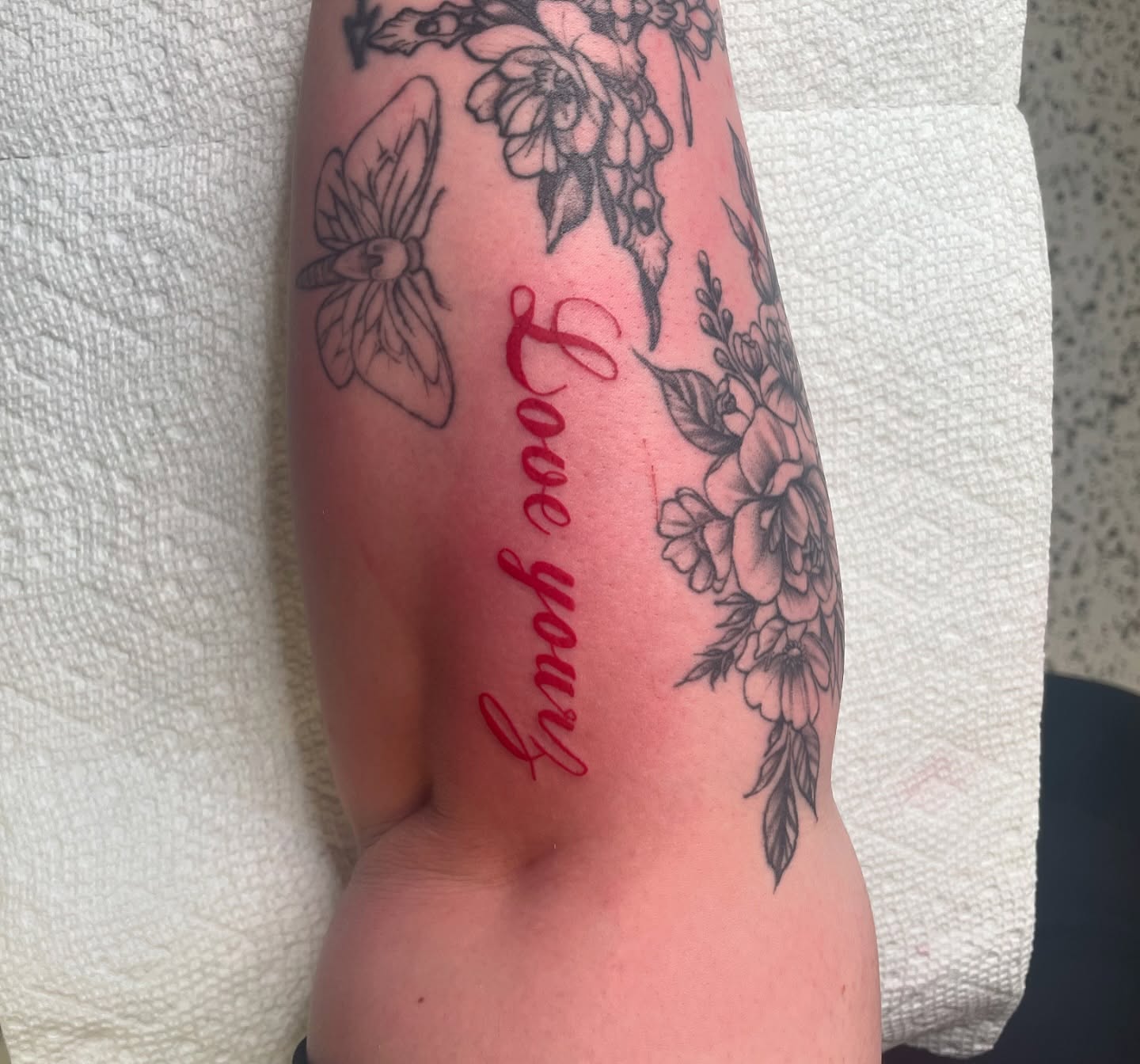 Love you black and grey tattoo on the forearm by Nyah Ramirez