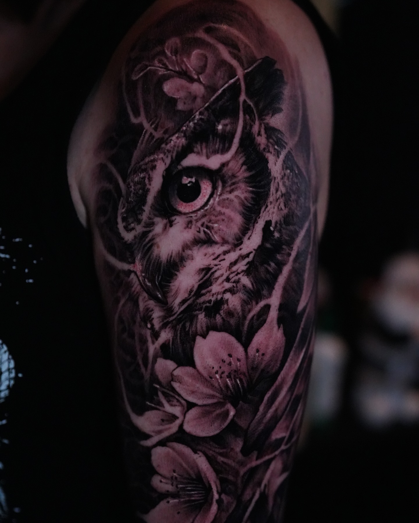 Owl and cherry blossoms realism tattoo on the forearm by Nico Perez