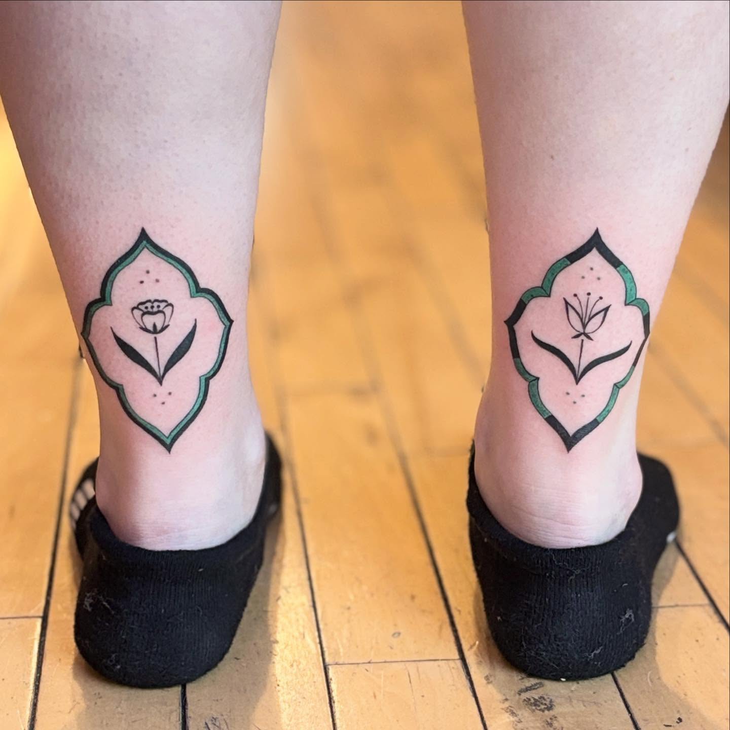 Floral design geometric tattoo on the calf by Reba Slate