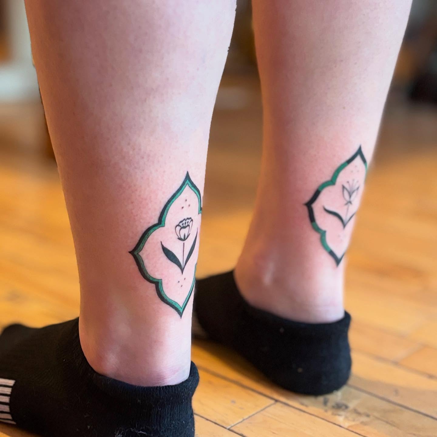 Flower geometric tattoo on the calf by Reba Slate