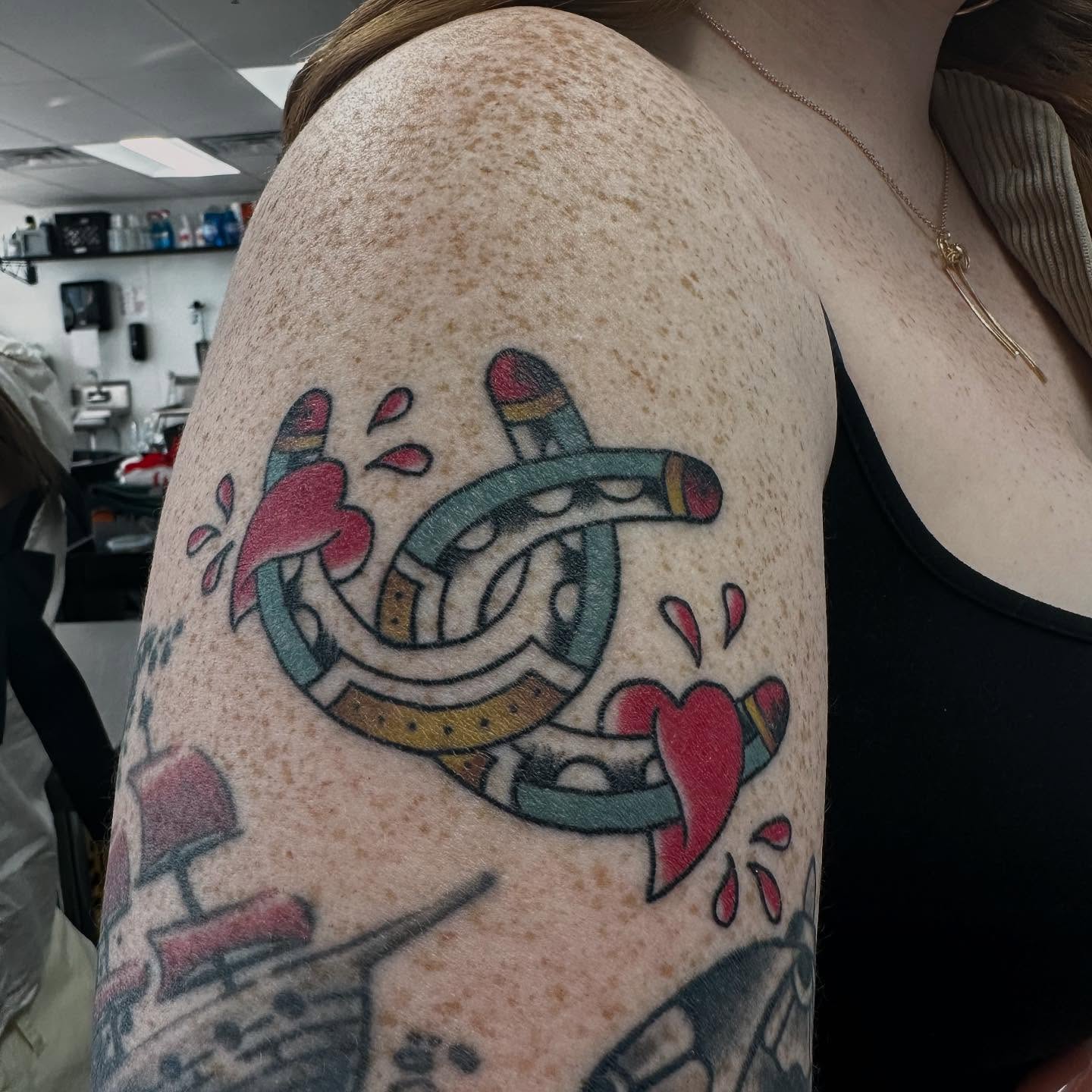 Horseshoe and hearts American traditional tattoo on the shoulder by Brendan Willbern, Austin, Texas