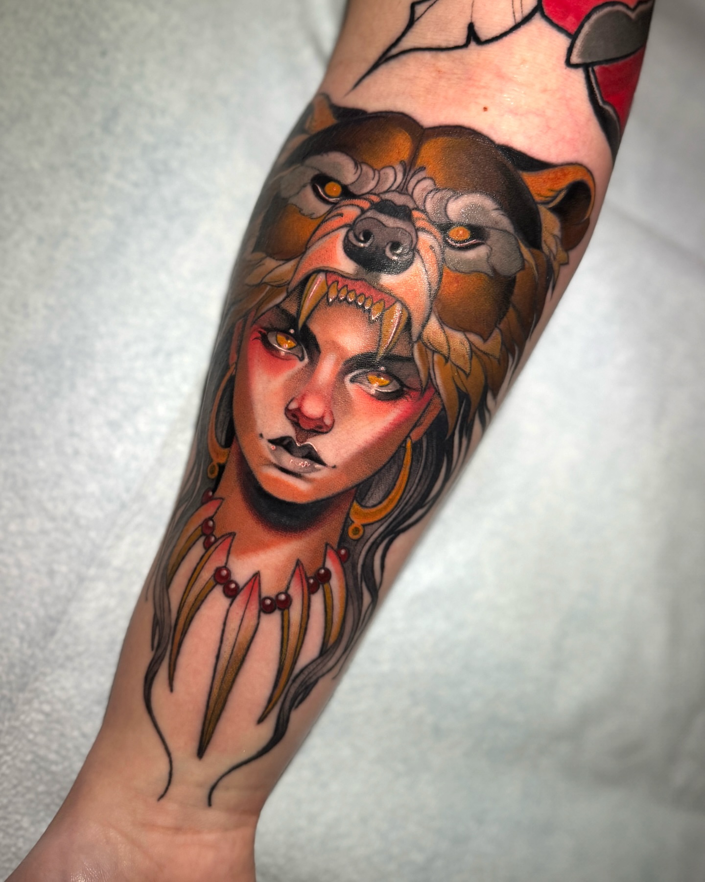 Woman with bear American traditional tattoo on the forearm by Matt - Neotrad Tattoos, New York, New York