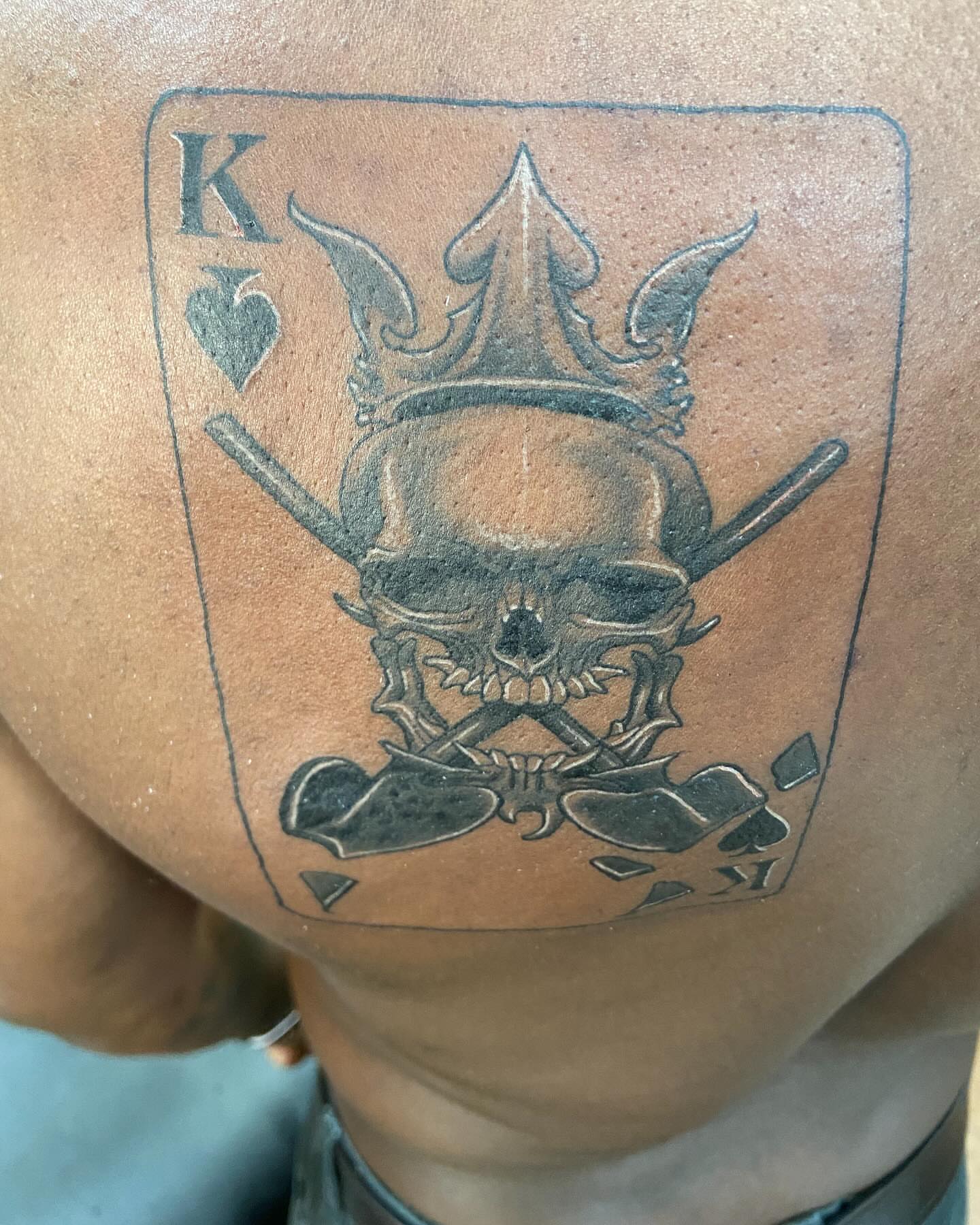 King of spades black and grey tattoo on the chest by Slade Nowicki