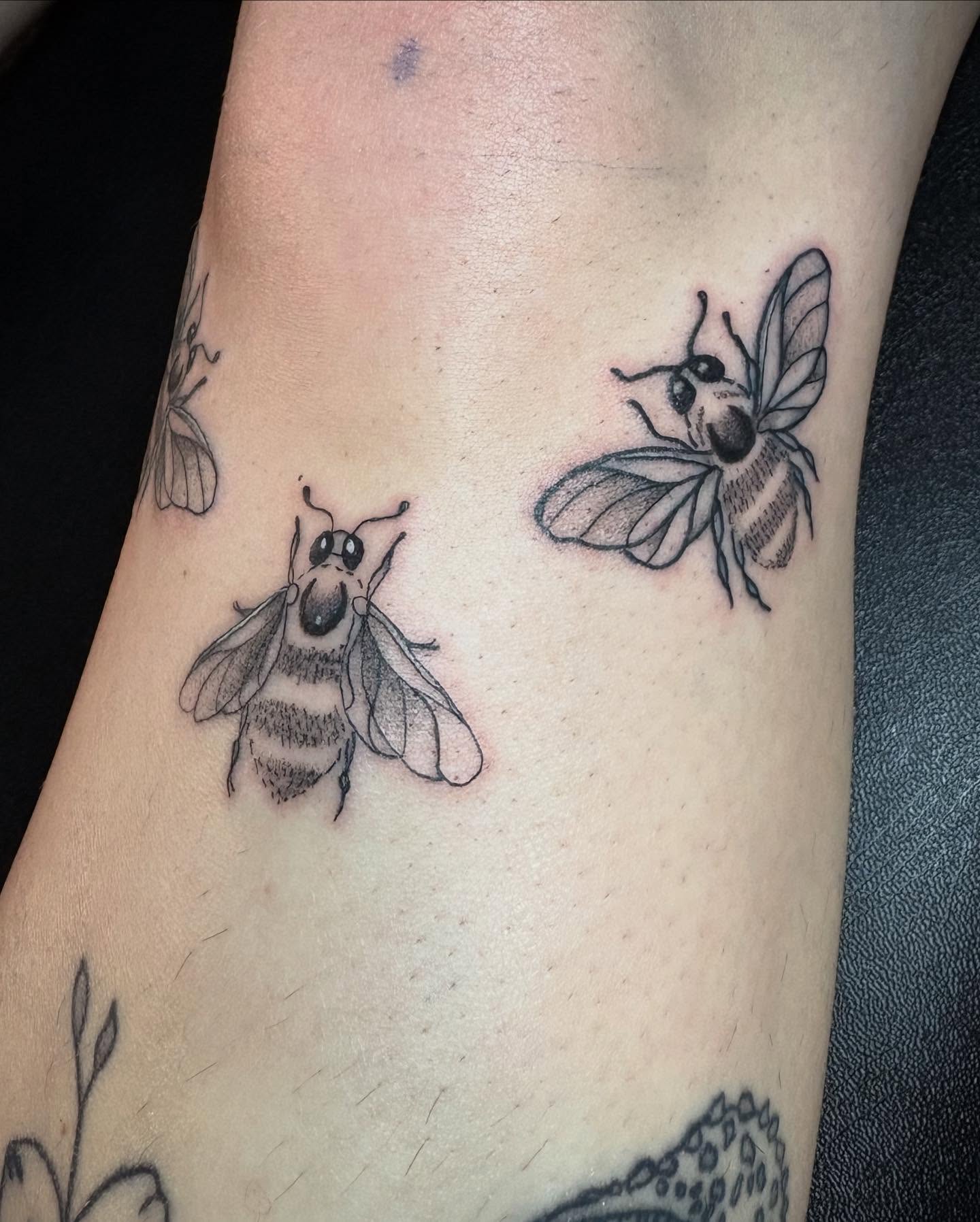 Bees black and grey tattoo on the forearm by Angel Arceo
