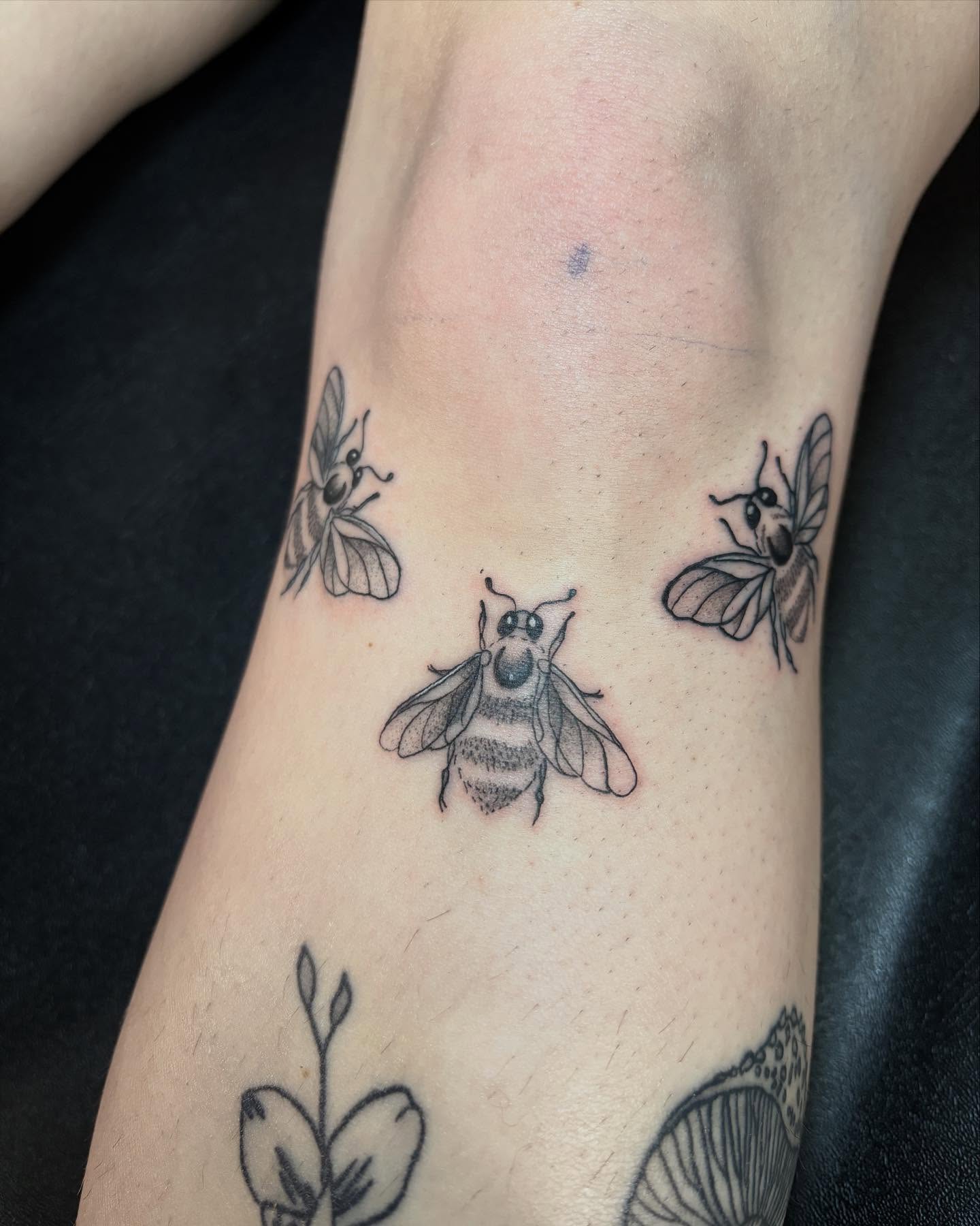 Bees black and grey tattoo on the forearm by Angel Arceo