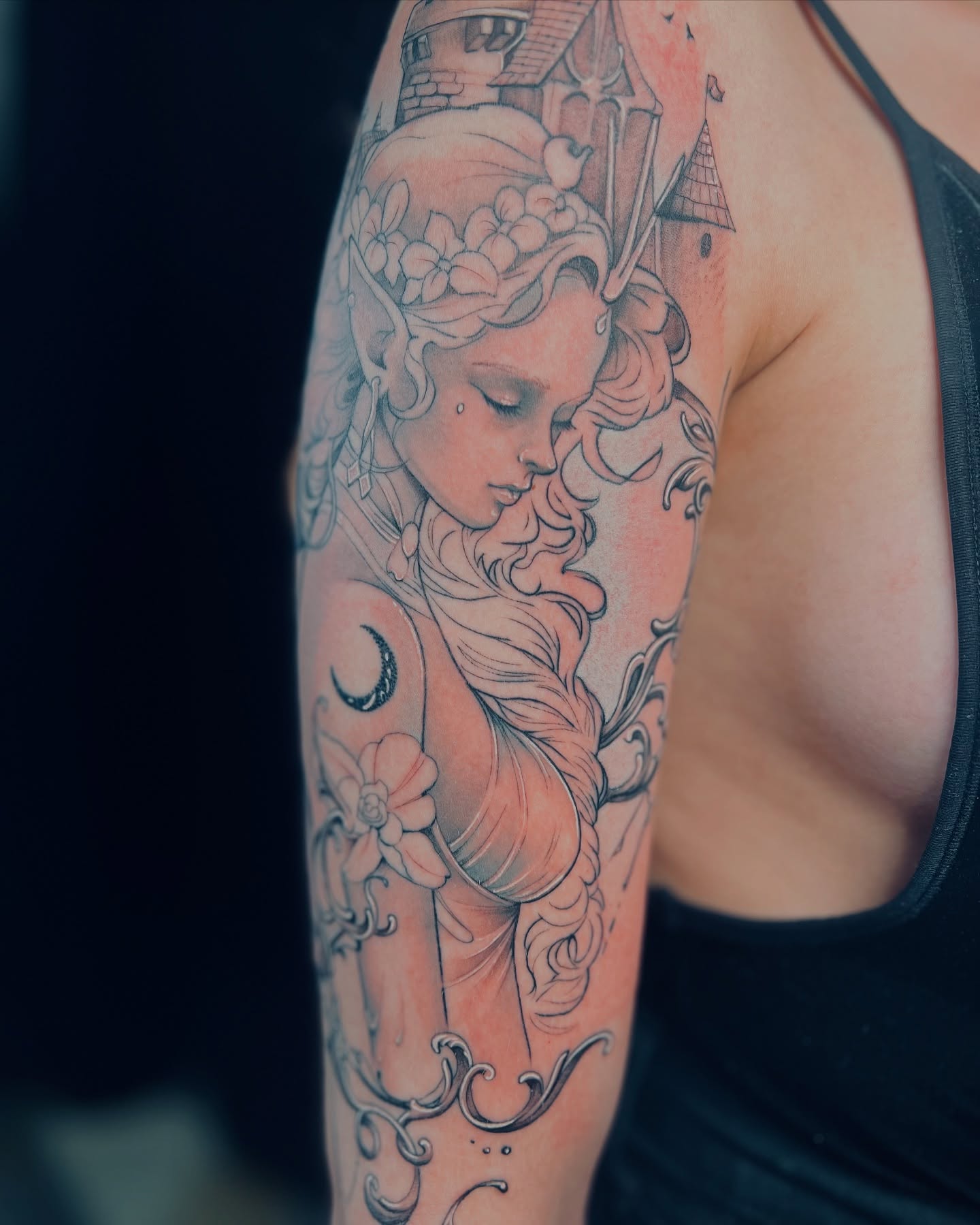Sleeping girl with flowers illustrative tattoo on the forearm by Apologies tattoo studios.