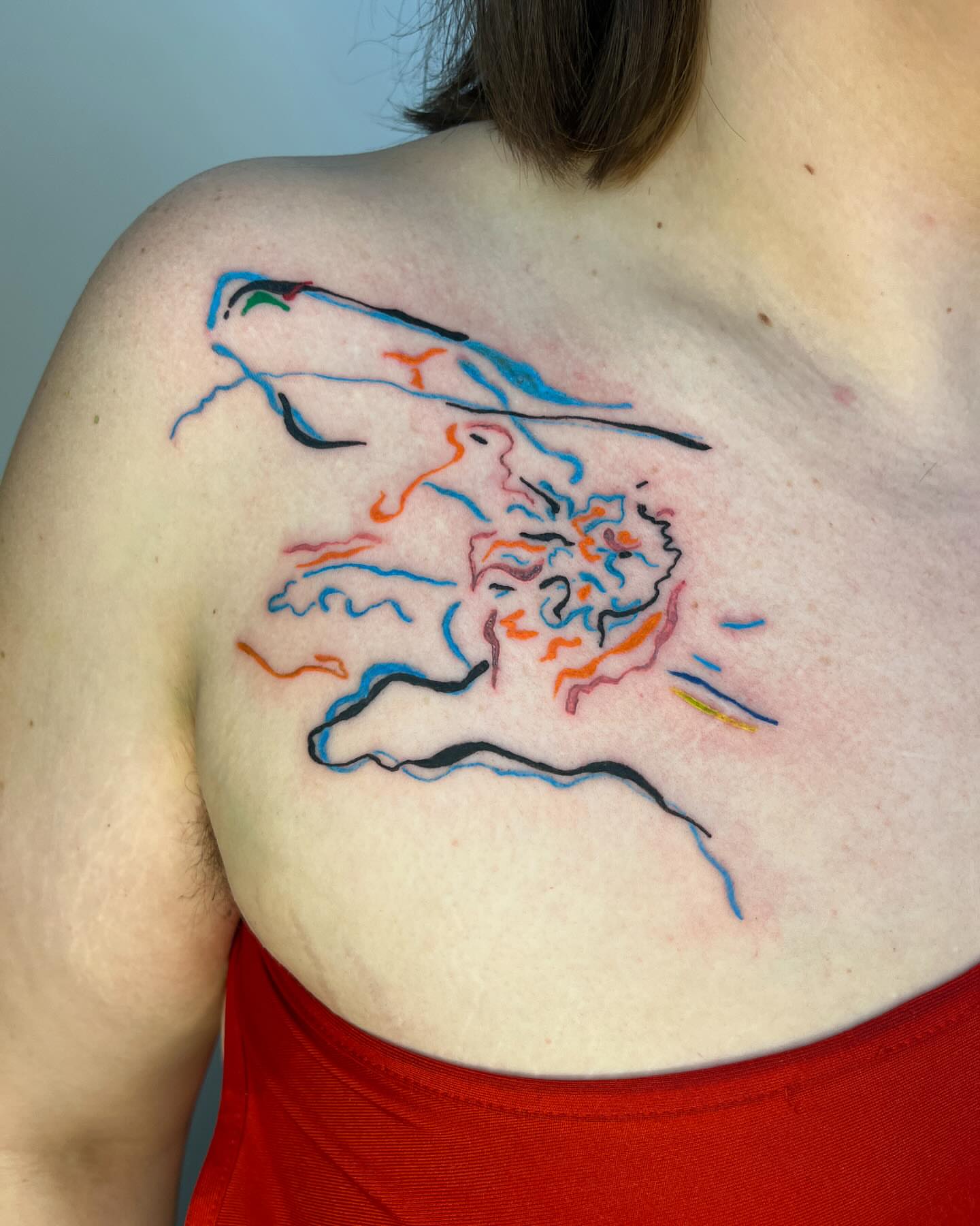 Abstract face tattoo on the back by tattoos by quin