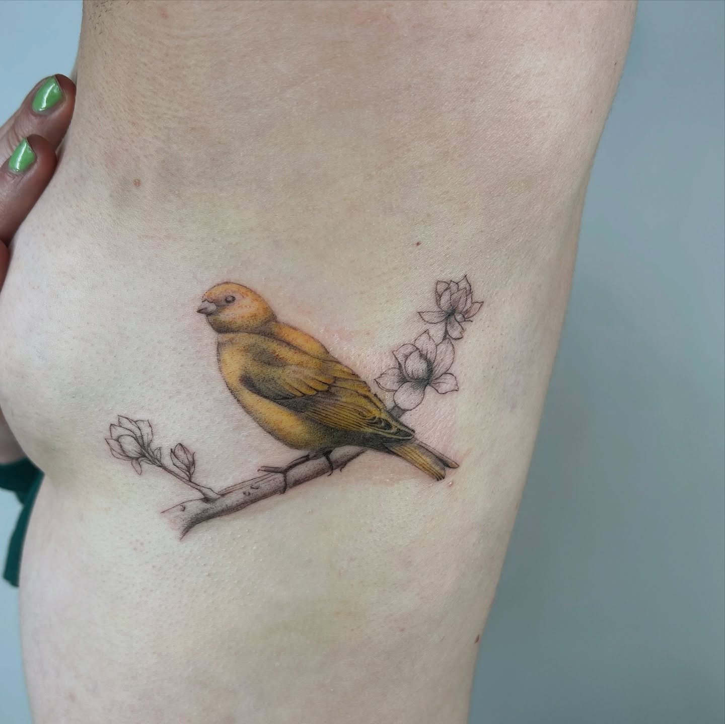Bird and flowers realism tattoo on the thigh by bre