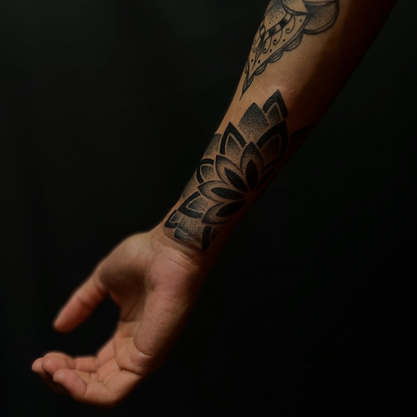 Lotus flower dotwork tattoo on the forearm by Stevie Reign