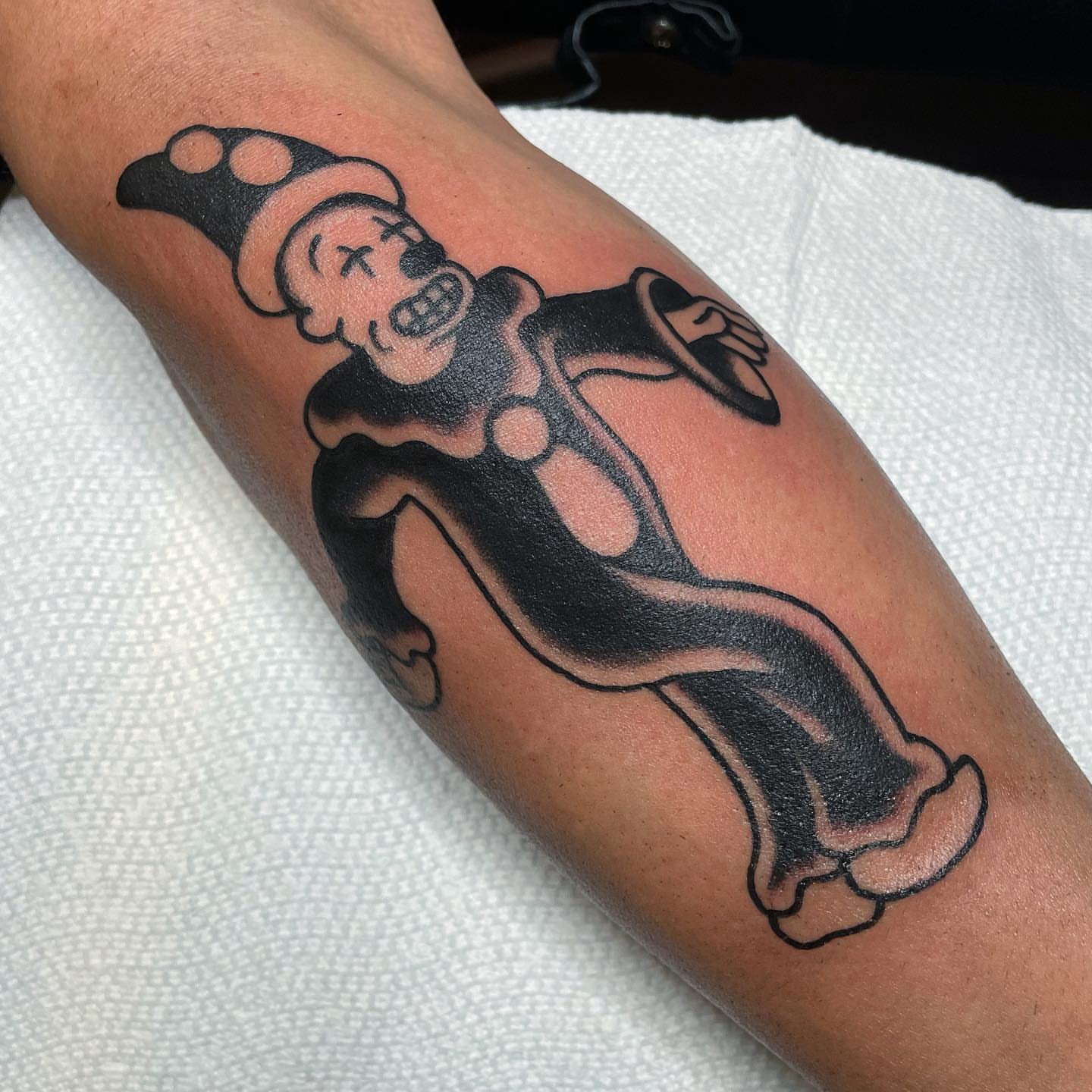 Pop art clown American traditional tattoo on the forearm by nancy❣️