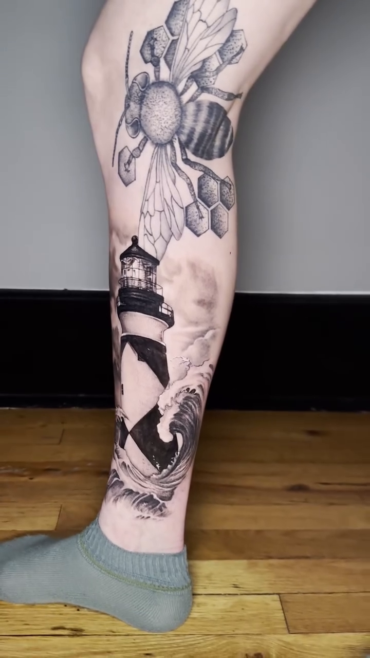 Lighthouse and flowers realism tattoo by Martina Zago