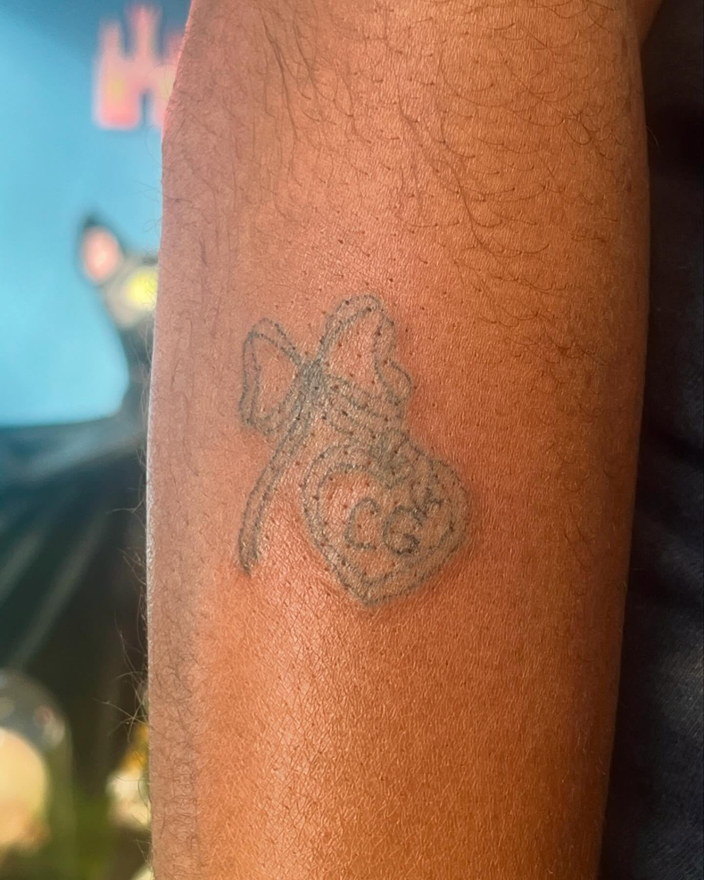 Bow and ribbon black and grey tattoo on the forearm by hana