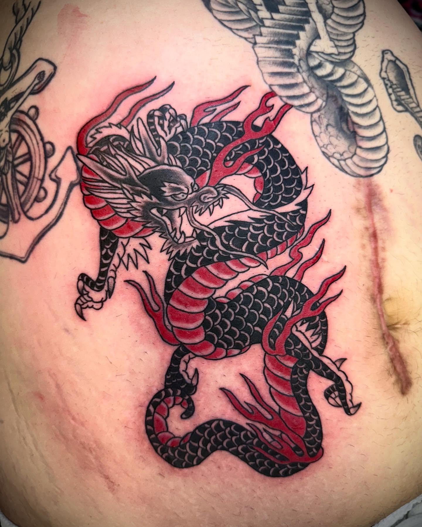 Dragon American traditional tattoo on the chest by Jameson William Cowan