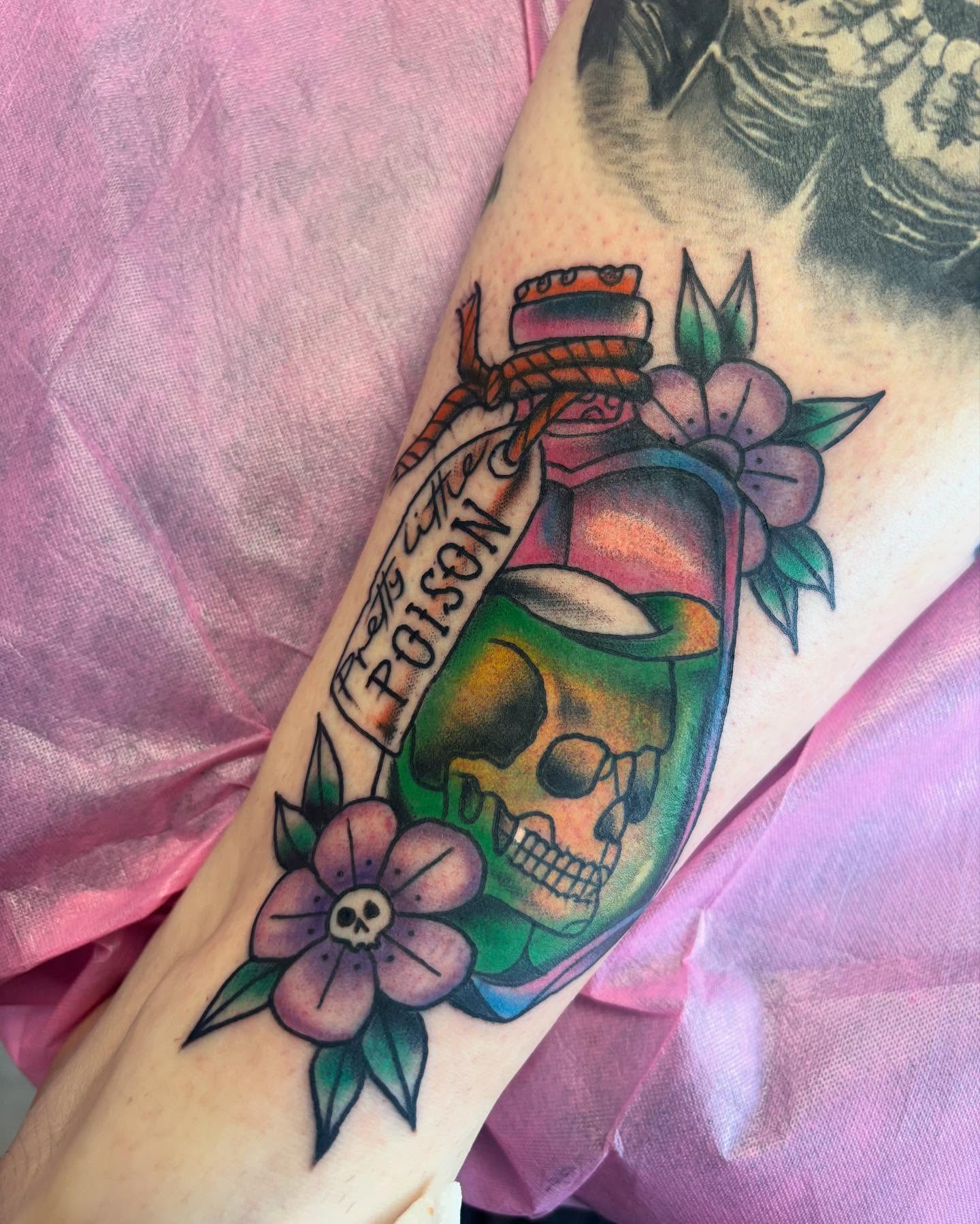 Poison bottle with skull American traditional tattoo on the forearm by 18 and older High End Tattoo