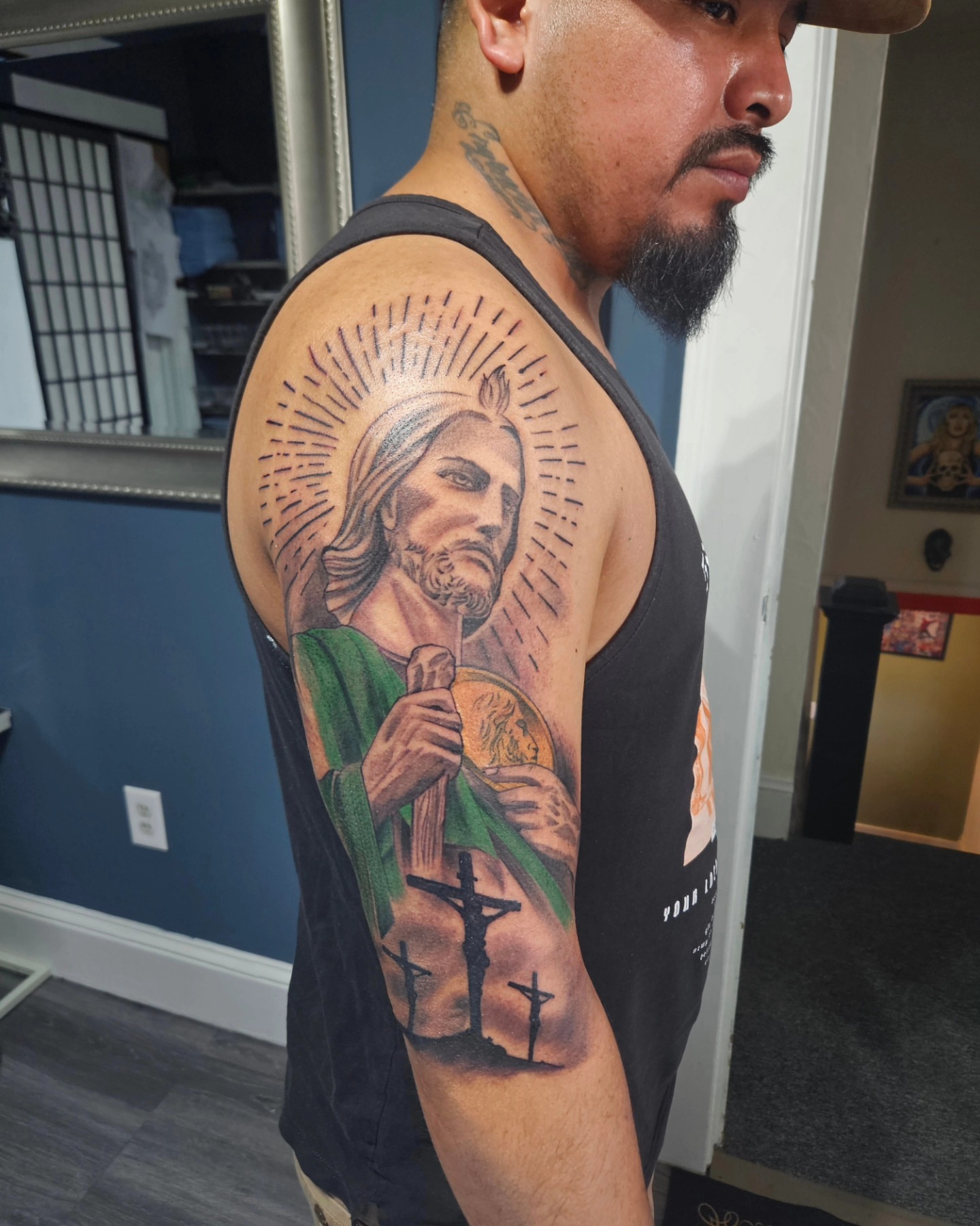 Religious figure realism tattoo on the upper arm by German Romero-Rendon