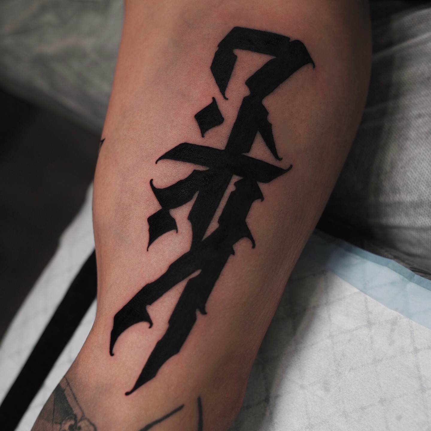 Kanji character black and grey tattoo on the forearm by Zlata