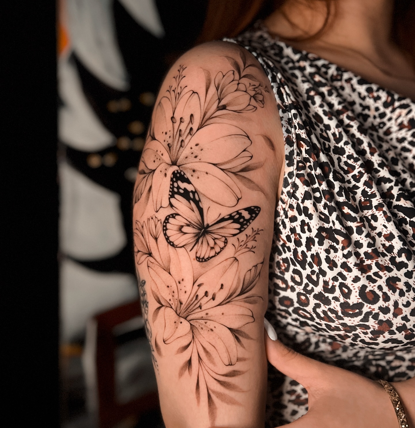 Lily and butterfly realism tattoo on the upper arm by πππΉππππππππππππ