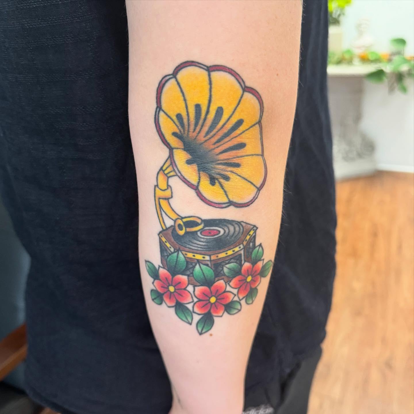Gramophone and flowers American traditional tattoo on the forearm by McKenna Chalifoux
