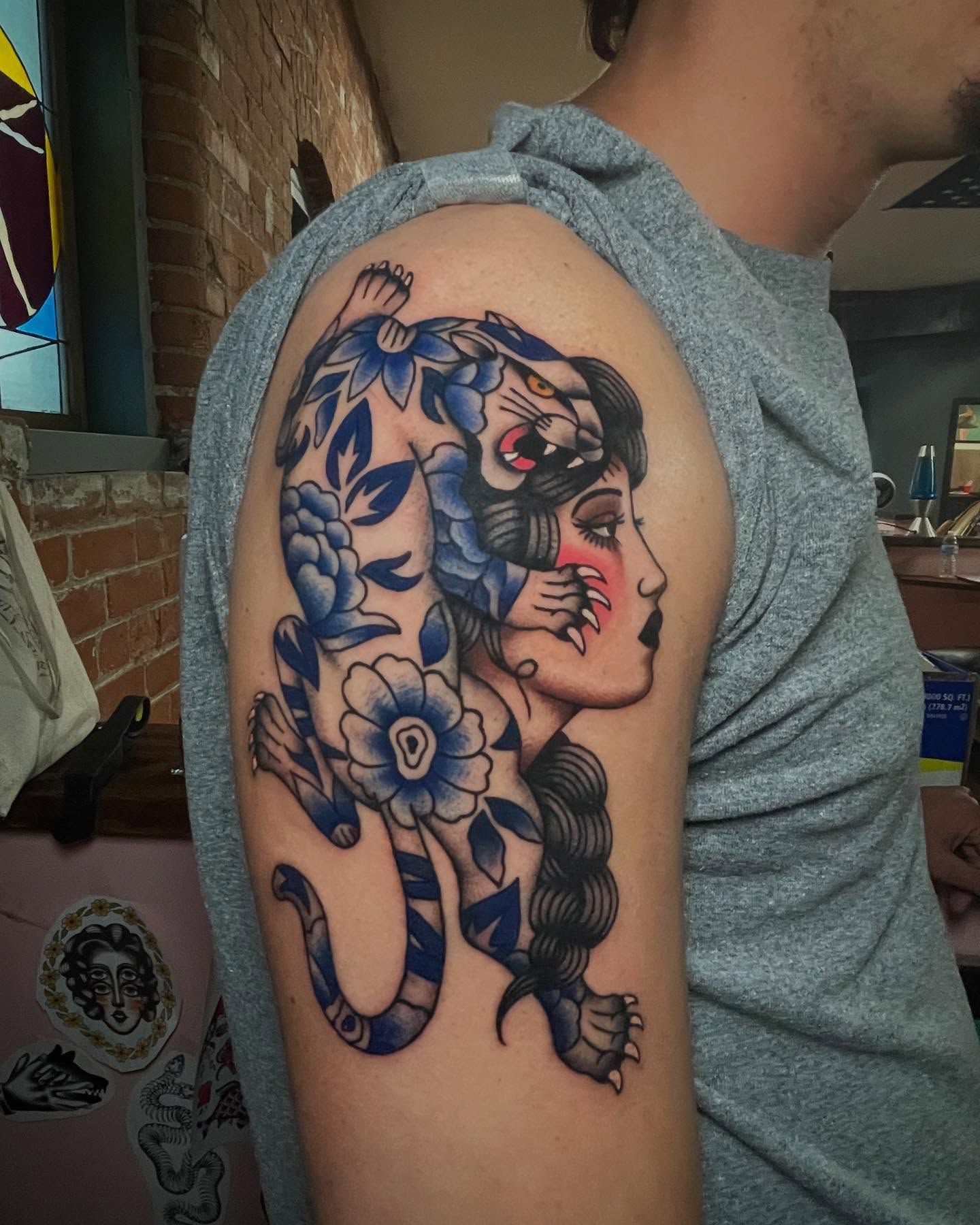 Woman with tiger American traditional tattoo on the shoulder by Marqui Watling