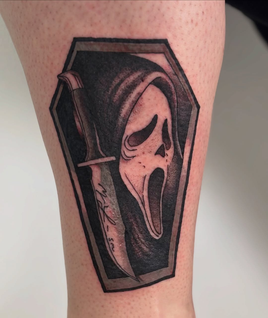Ghostface mask and knife realism tattoo on the forearm by Sterling Paris