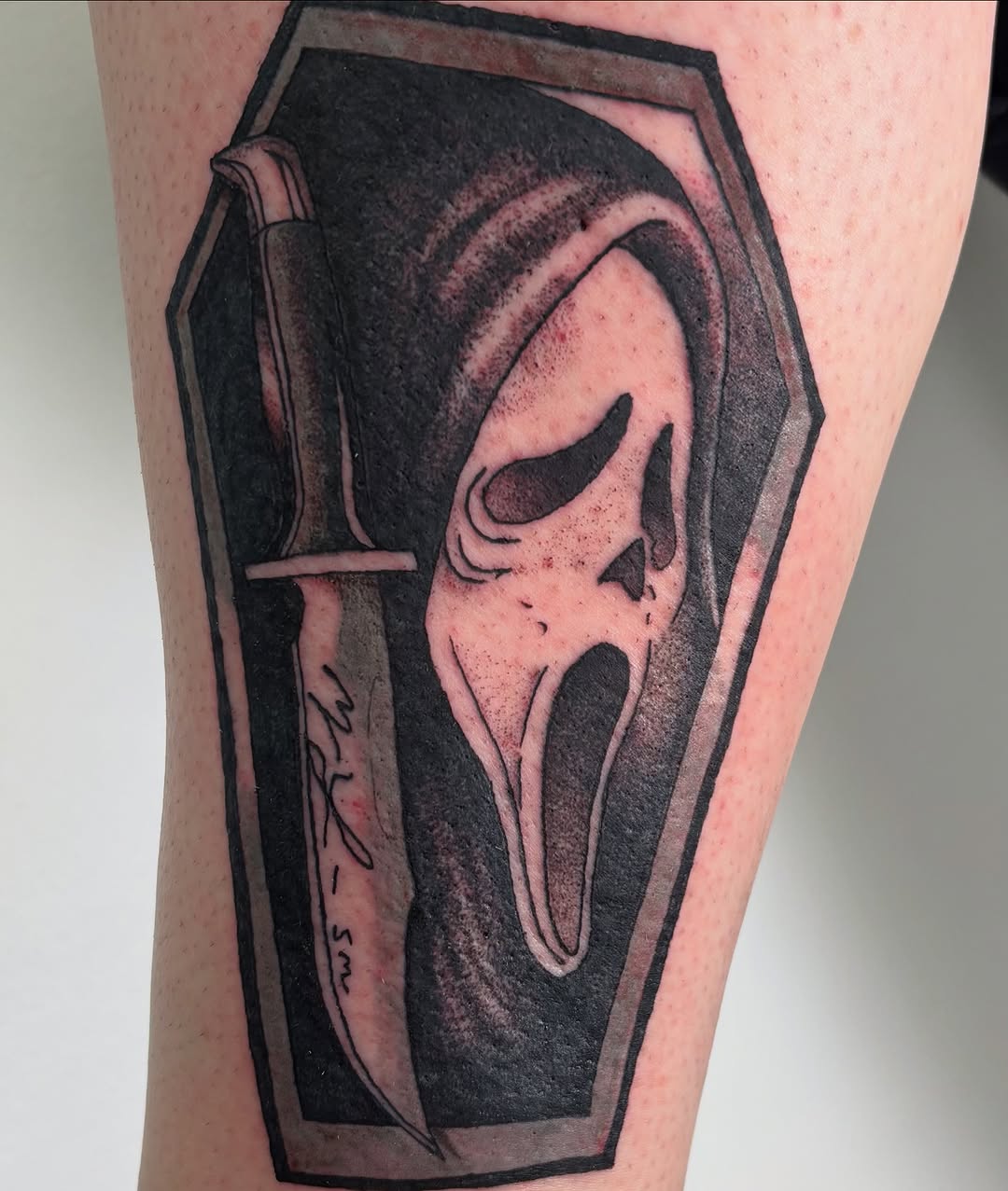 Ghostface mask in coffin with knife realism tattoo on the thigh by Sterling Paris