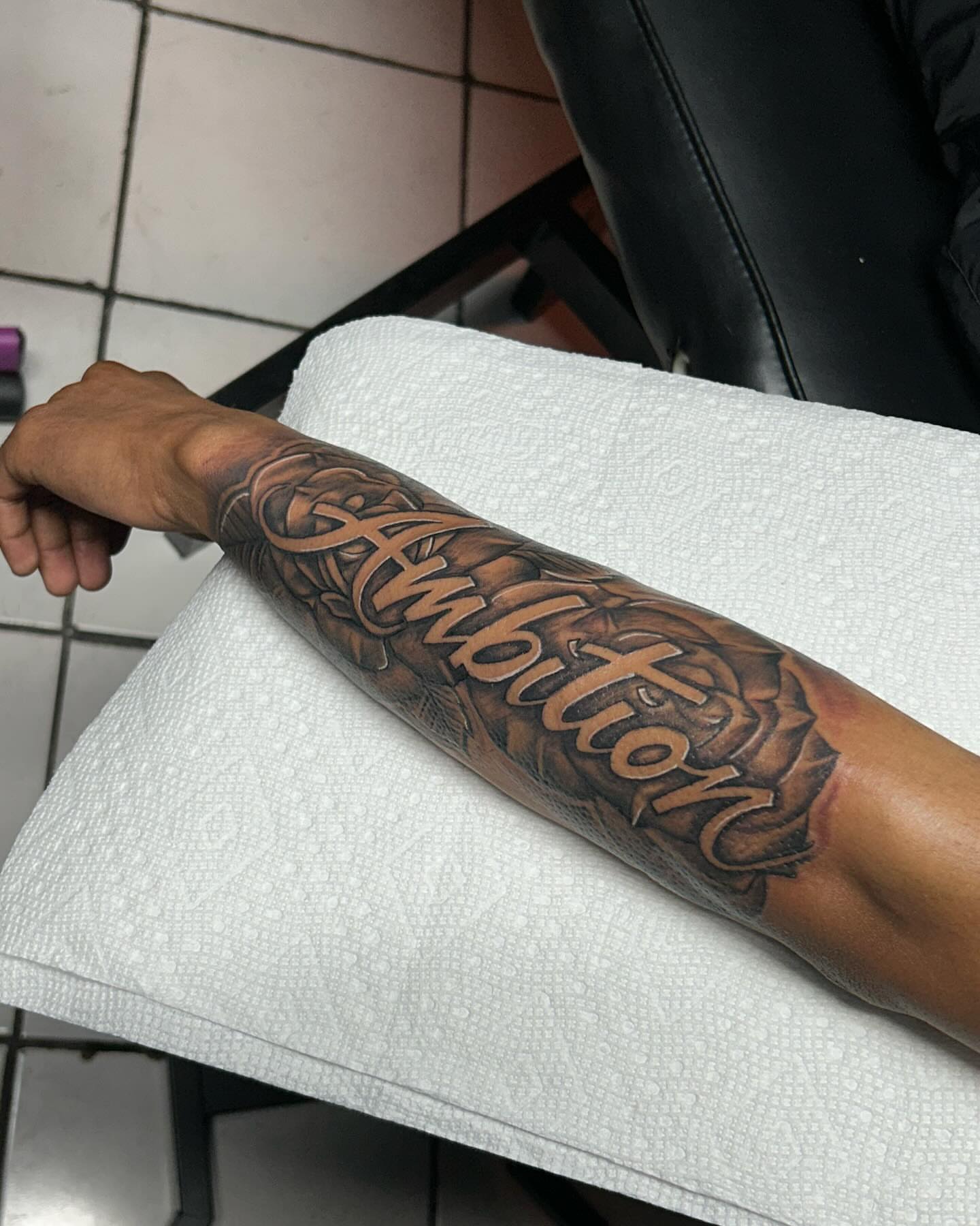 Ambition black and grey tattoo on the forearm by GrindHard Quen