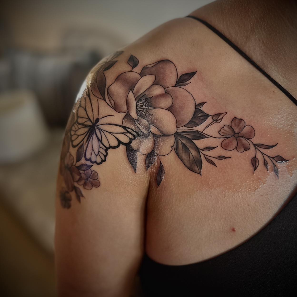 Floral bouquet black and grey tattoo on the shoulder by PMU Artist