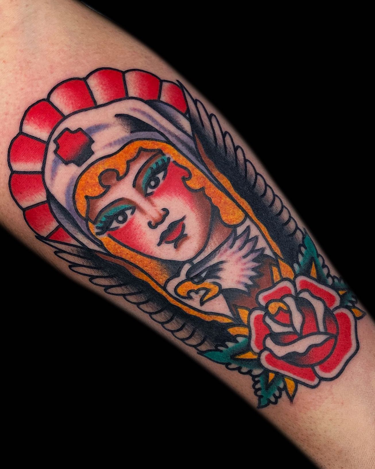 Woman with halo American traditional tattoo on the forearm by The Calamari Kid