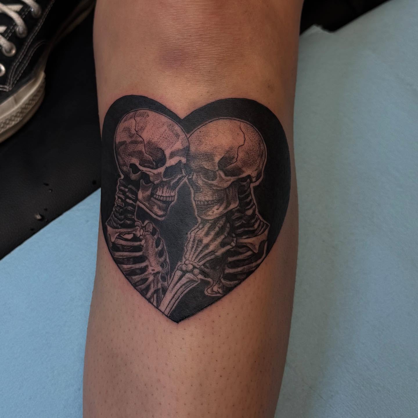 Skeletons in heart realism tattoo on the forearm by Elian Sanchez Austin Tx. Tattoo Artist