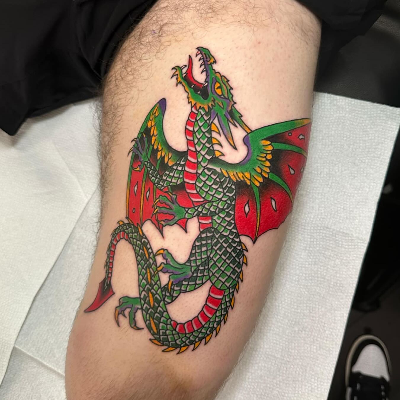 Dragon American traditional tattoo on the thigh by 𝕯𝖗𝖊𝖜 𝕲𝖎𝖑𝖊𝖘 𝕵𝖆𝖙𝖙𝖔𝖔, Addison, Texas