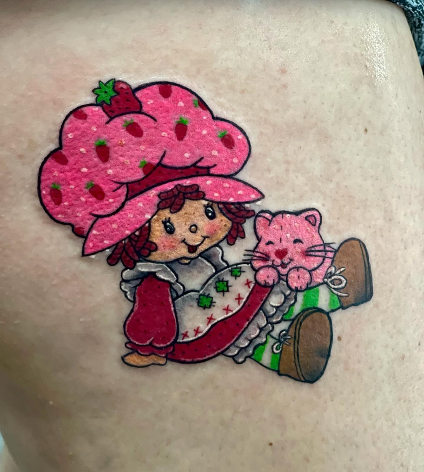 Strawberry shortcake character illustrative tattoo on the thigh by Missy (Miz)