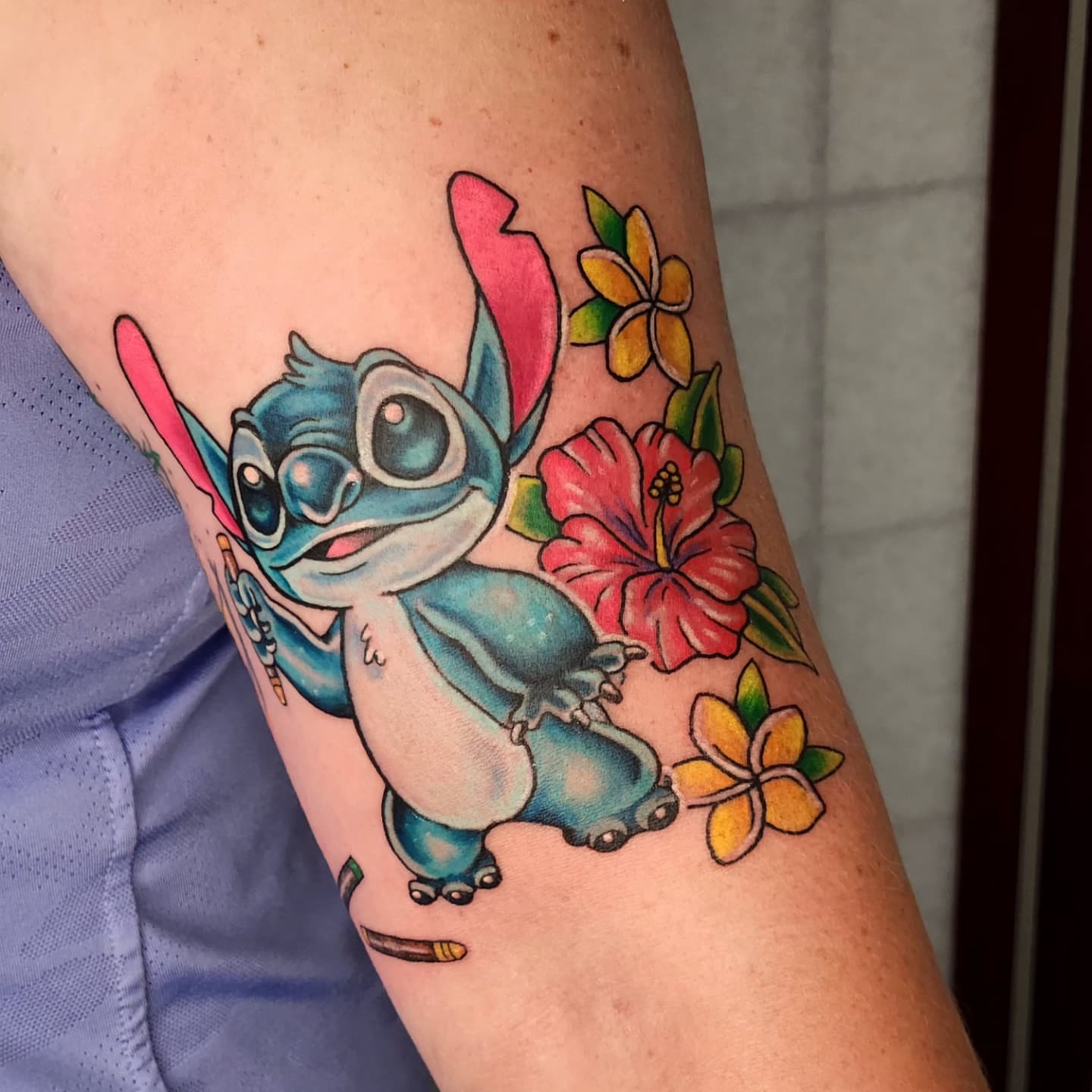 Stitch and flowers new school tattoo on the forearm by Elizabeth Stepp