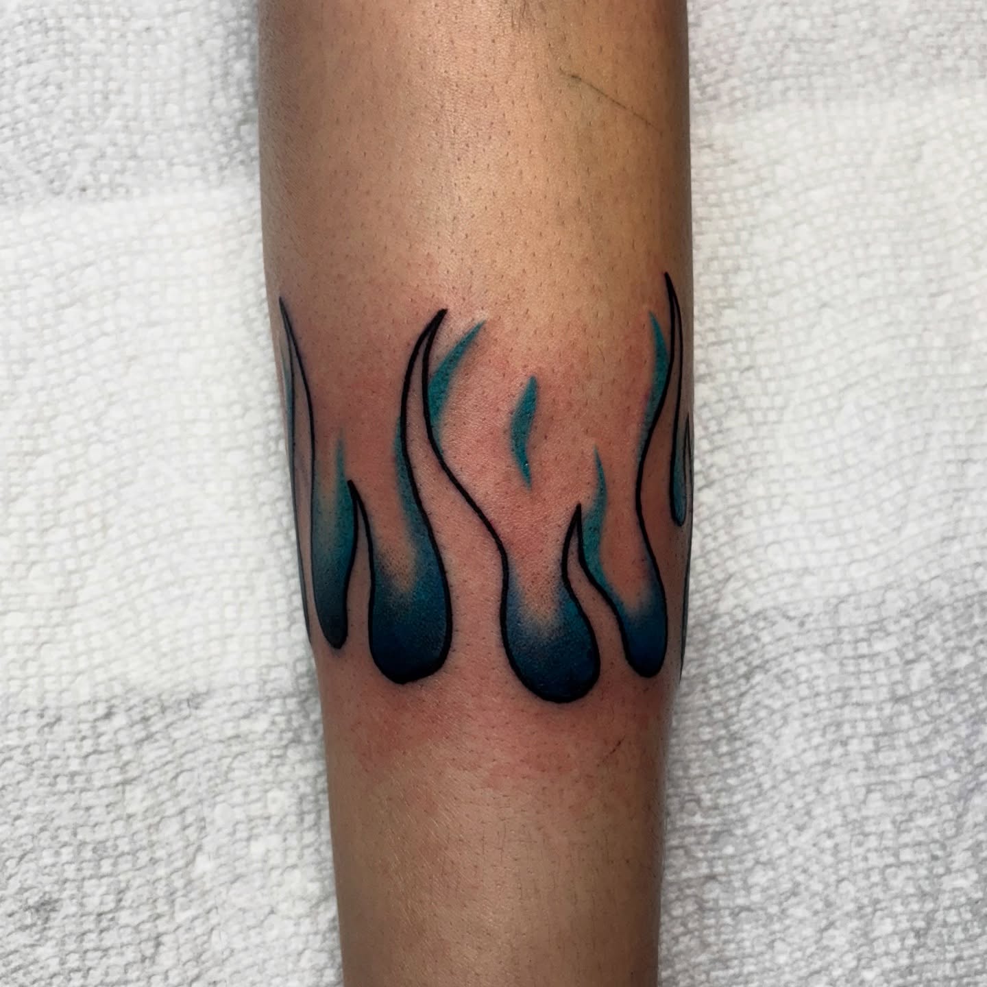 Flames new school tattoo on the forearm by Dyllan Shipley