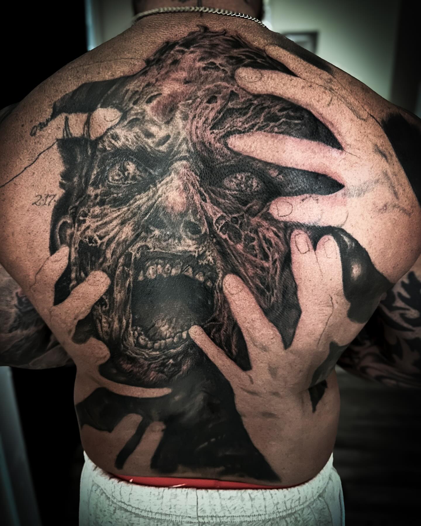 Zombie dark realism tattoo on the back by Neil5one3