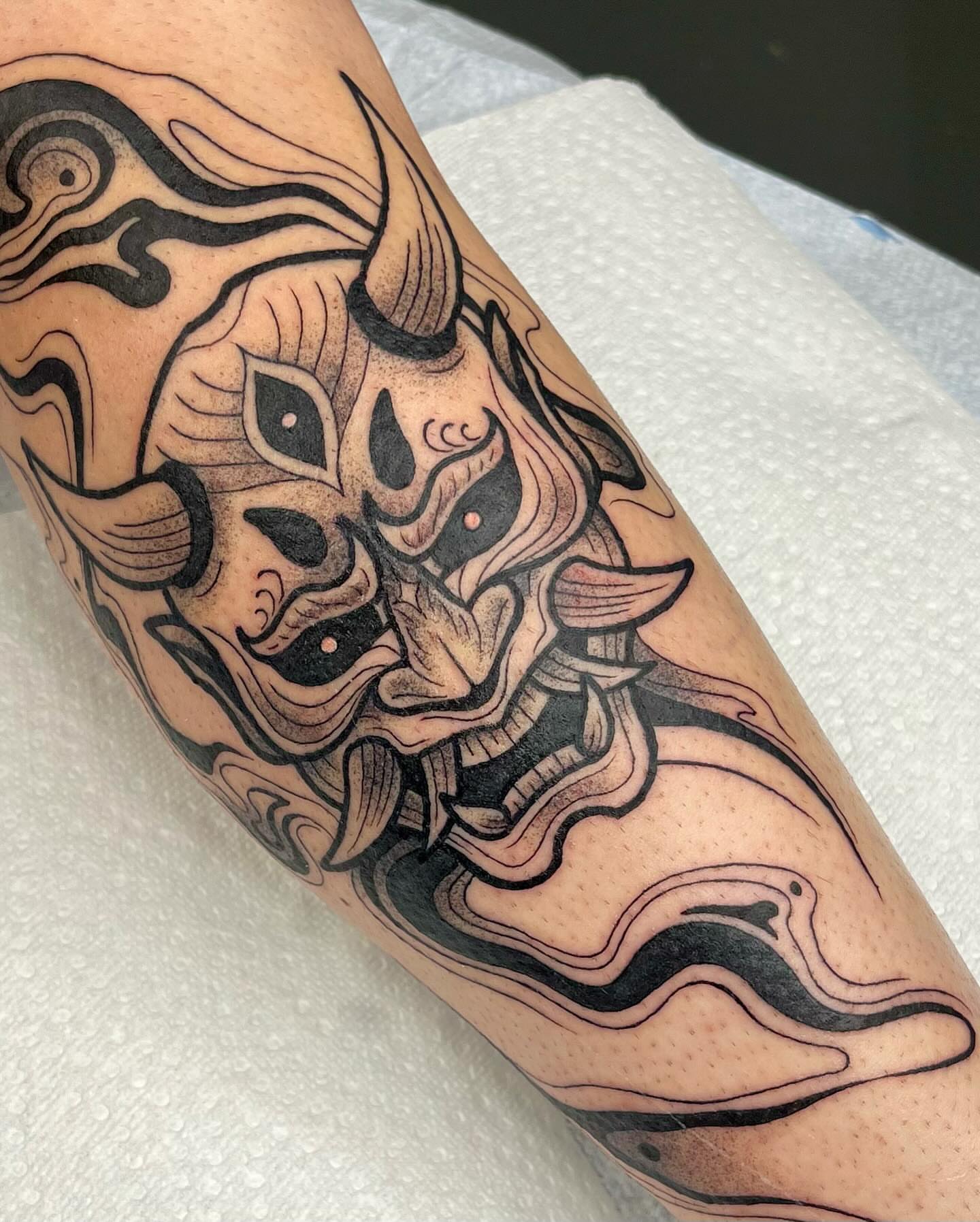 Bull mask black and grey tattoo on the forearm by Erin Blaney