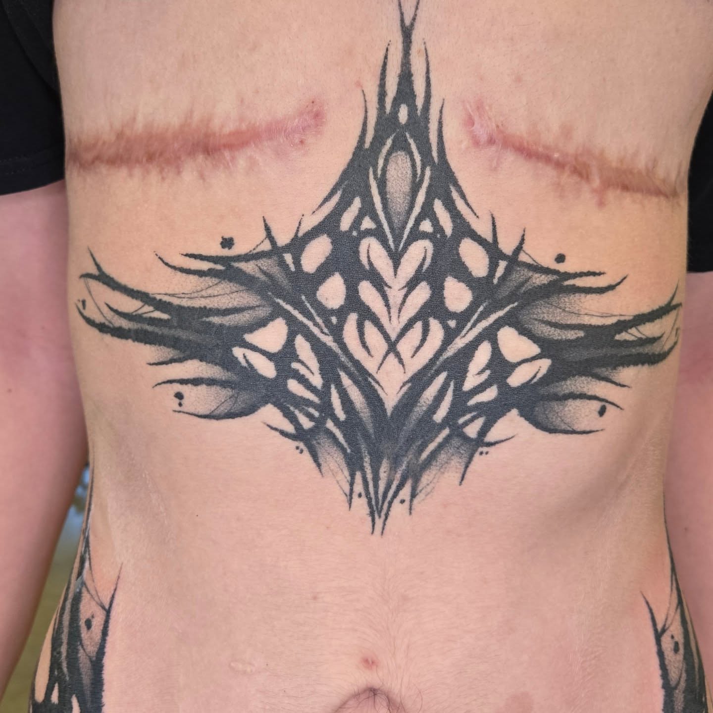 Abstract geometric design geometric tattoo on the ribs by Kylie