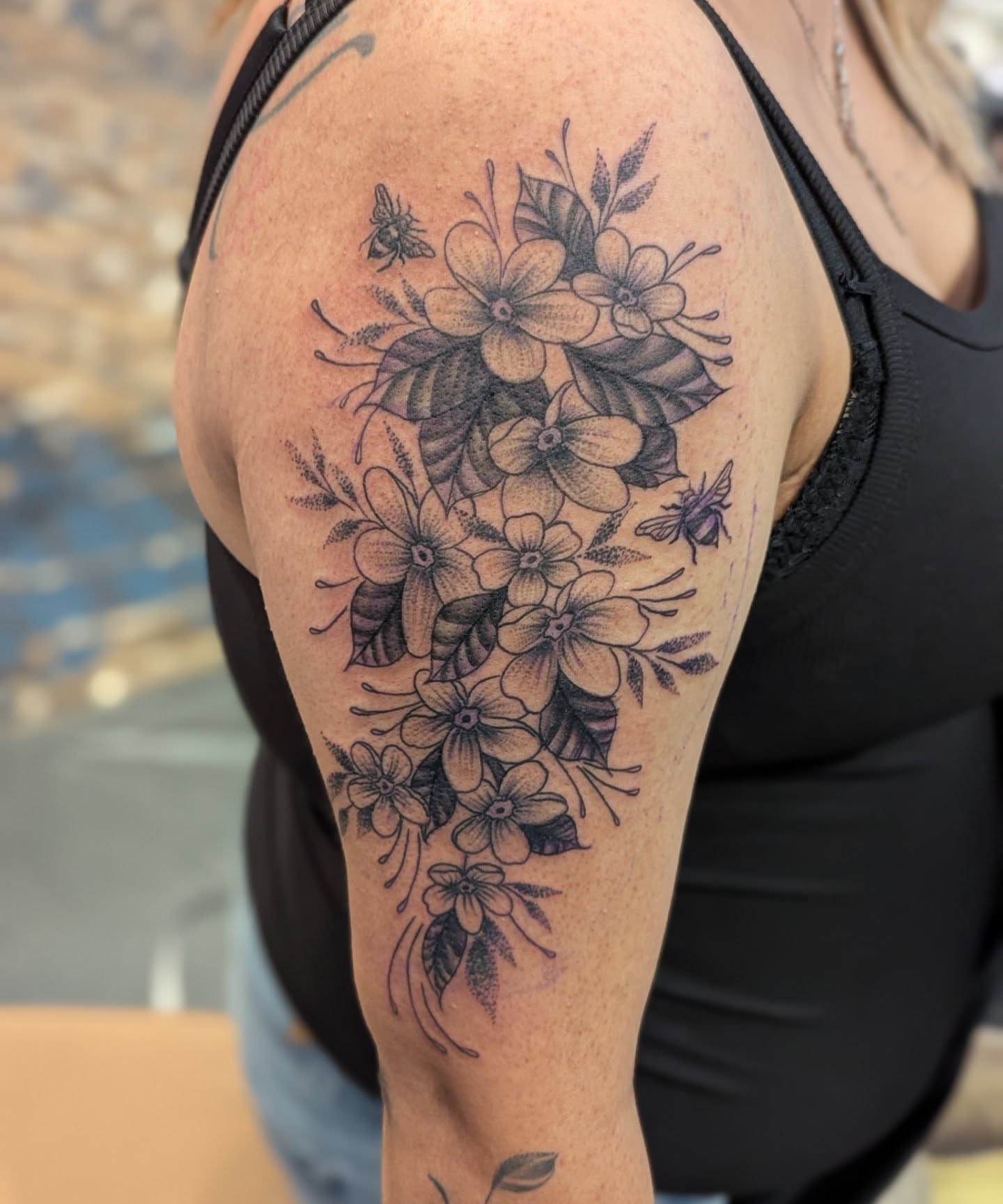 Flowers and bees black and grey tattoo on the shoulder by Claudia Isabel Roman, El Paso, Texas